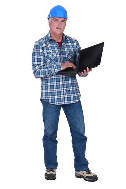 Tradesman holding a laptop - Фото, зображення