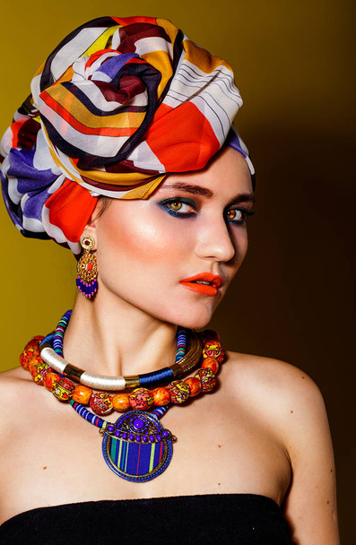 Beautiful woman in oriental style in turban - Fotó, kép