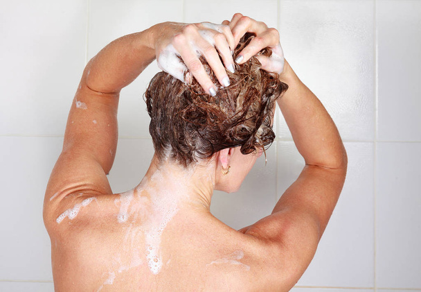 Βολή closeup της γυναίκας πλύσιμο τα μαλλιά της σε ένα ντους - Φωτογραφία, εικόνα