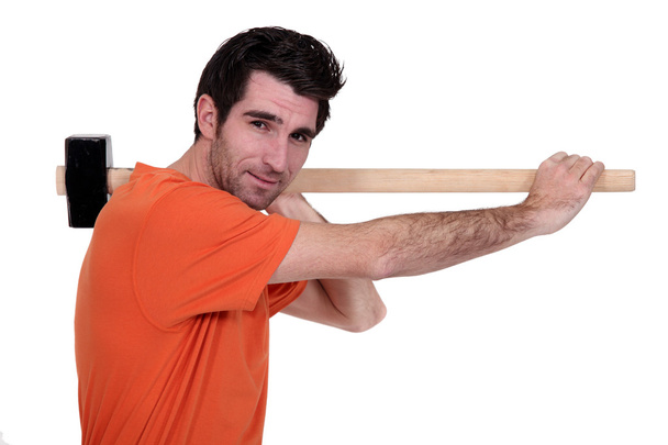 Craftsman holding a hammer on his shoulder - Photo, Image