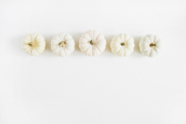 Beige pumpkins on white background - Valokuva, kuva