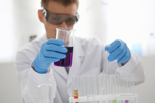 Un chimiste masculin tient un tube à essai en verre
 - Photo, image