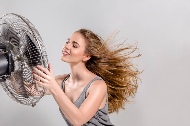 Young woman with cooler fan - Фото, зображення