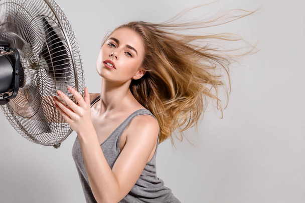 Young woman with cooler fan - Фото, зображення