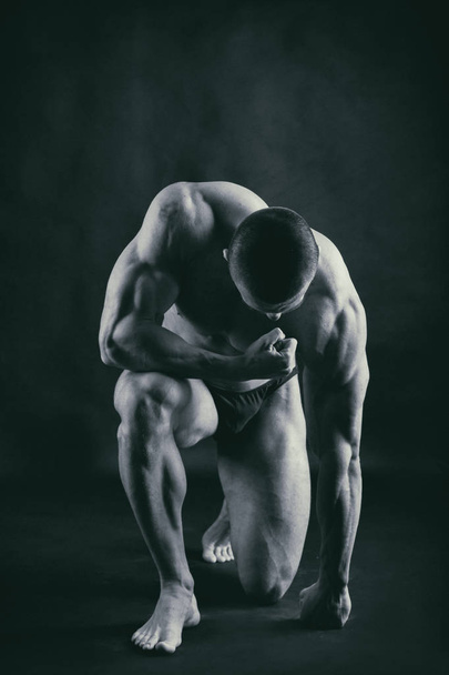 Strong with muscular body at the gym - Φωτογραφία, εικόνα