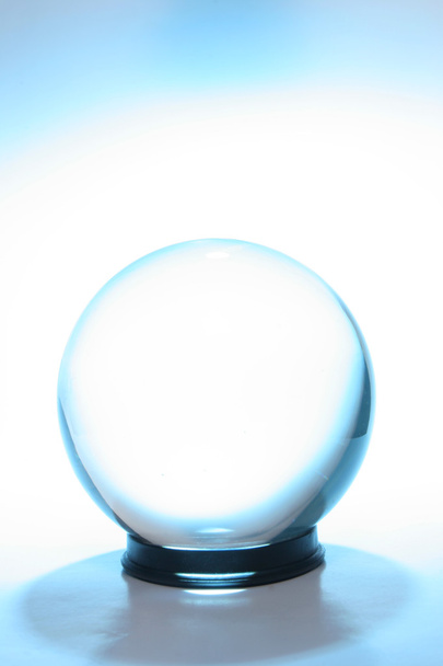Crystal ball surrounded by blue light - Foto, Imagen