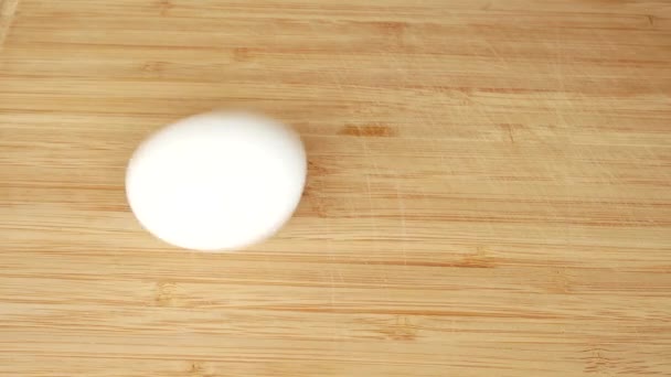 a man turns a chicken egg to understand whether it is cooked or raw. boiled egg turns quickly. 4k. copy space - Metraje, vídeo
