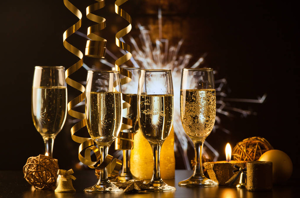 champagne glasses against holiday lights ready for New Year's ev - Photo, Image