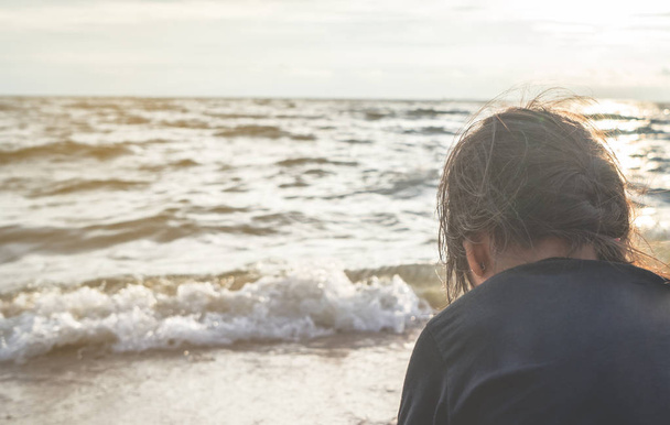 Behind of a little girl facing out to the sea ocean  - Fotoğraf, Görsel