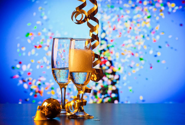 two champagne glasses with ribbons and falling confetti - New Ye - Photo, Image