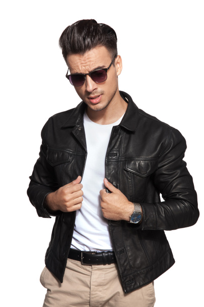 cool young fashion man pulling leather jacket 's collar
  - Фото, изображение
