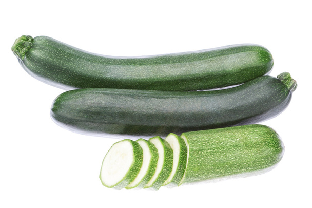 Three vegetable zucchini cut into pieces. On a white background. - Zdjęcie, obraz