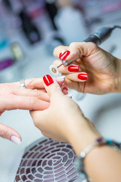 Nail Care and manicure. Nail care and the techniques of gel nail application - Foto, imagen