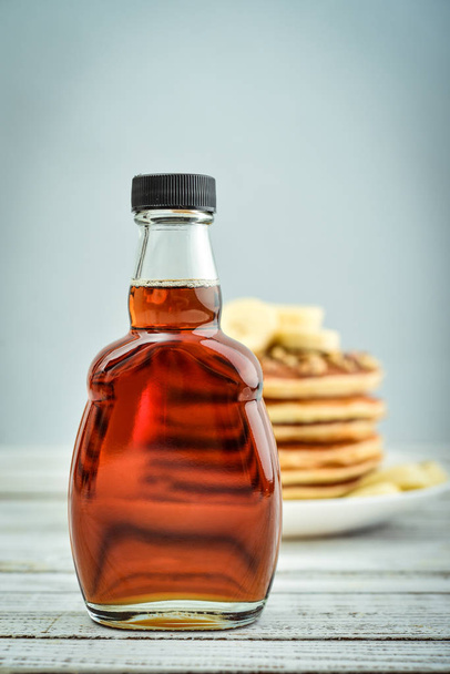 Maple syrup in glass bottle - Fotoğraf, Görsel