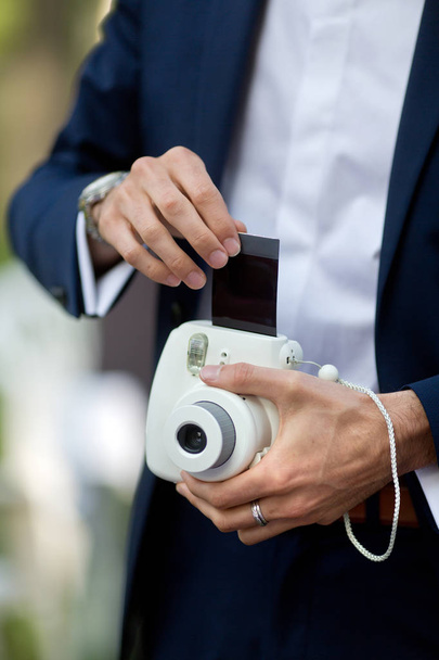 man taking instant photos with camera - Photo, Image