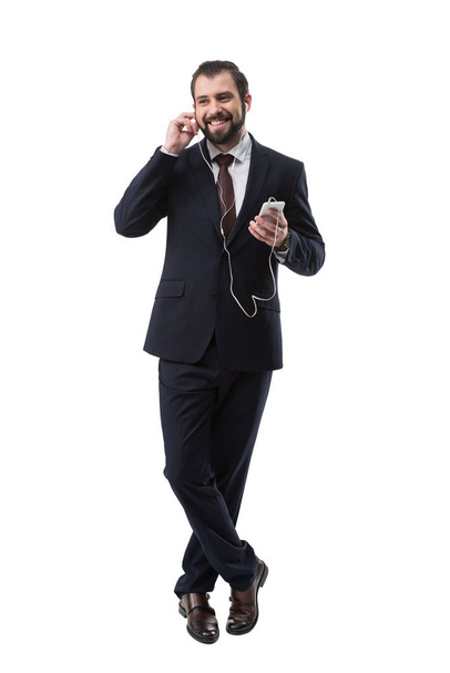 smiling businessman listening music - Фото, зображення
