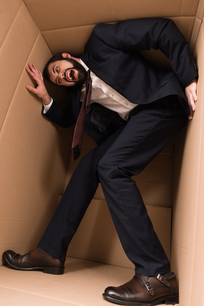 stressed businessman in cardboard box - Photo, Image