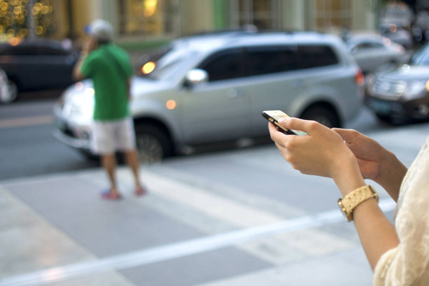 A woman is holding her cellphone - Photo, Image