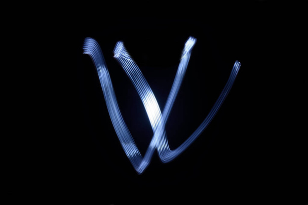 paint with light on black background letter W - Photo, Image