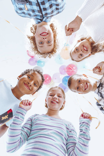 Colorful balloons hanging above kids - Zdjęcie, obraz