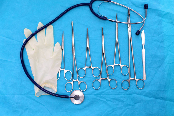 surgical instruments and tools including scalpels, forceps and tweezers arranged on a table for a surgery - Photo, Image