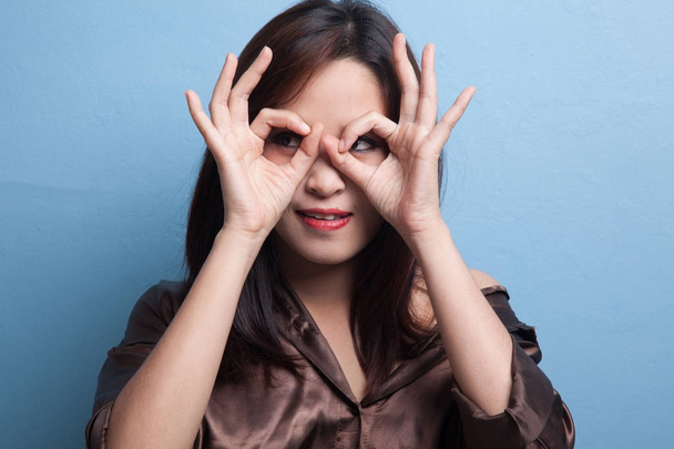 Asian woman do funny  double OK sign as glasses. - Valokuva, kuva
