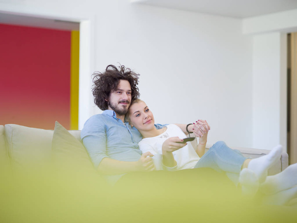 Young couple on watching television - Фото, изображение
