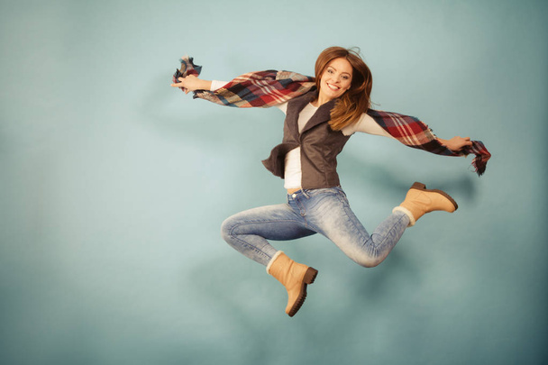 Woman fashion autumn girl jumping, flying in air on blue - Фото, изображение