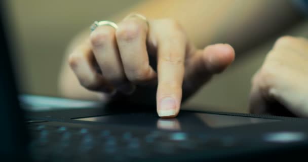 Крупный план женской руки с помощью сенсорной панели на ноутбуке, сидя за столом дома
 - Кадры, видео