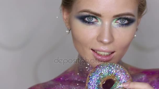 Beauty fashion model girl taking sweets and colorful donuts. - Footage, Video