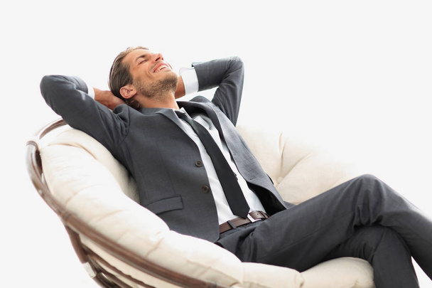 young businessman meditating in big comfortable armchair - Zdjęcie, obraz