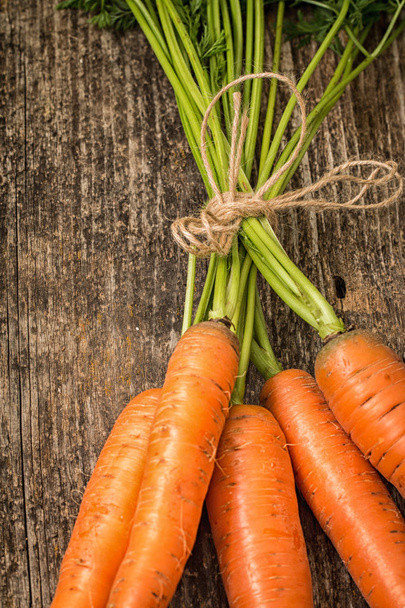 Fresh Organic Carrots  on wooden background - Foto, afbeelding