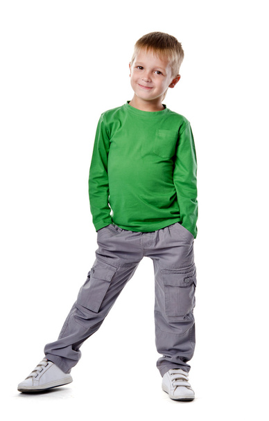 Portrait of a happy little young boy standing with hands in pock - Foto, Imagen