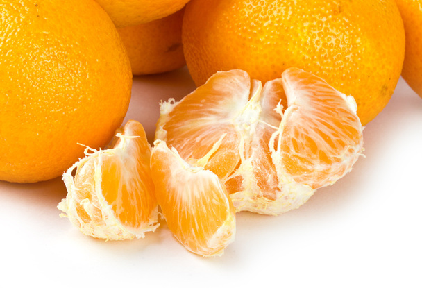 Fresh mandarin fruits with cut on white - Foto, afbeelding