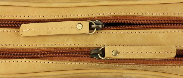 pair of zippers on the yellow  leather bag, top view - Photo, Image