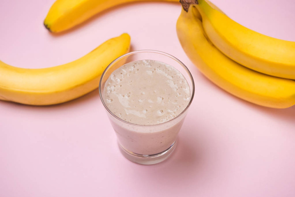 Banana Smoothie on a yellow background. Selective focus - Photo, Image