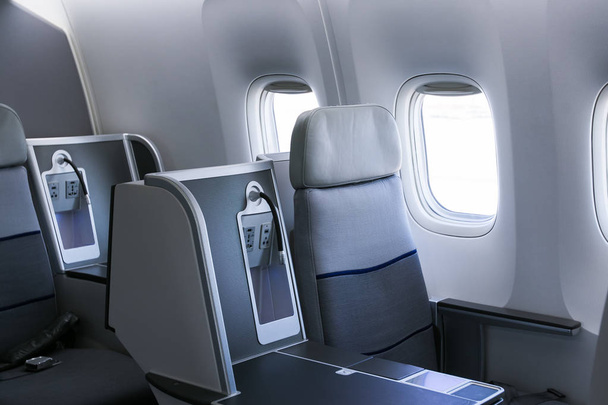 Lege stoelen en venster binnen een vliegtuig - Foto, afbeelding