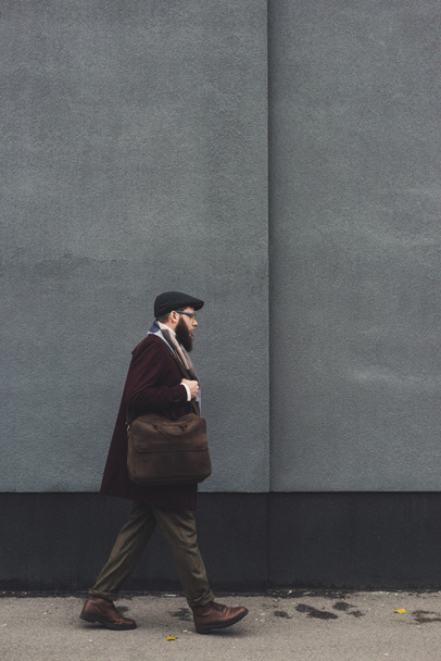 man in stylish clothing walking on street - Фото, зображення
