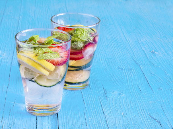 Dietary detox drink with lemon juice, strawberries and cucumber. - Fotó, kép