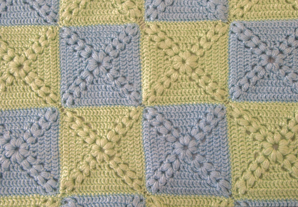 Knitted handmade colourful blankets blue and green, gentle colors. Colorful original knitted handmade work. Crochet stitches. Rustic background - Photo, Image