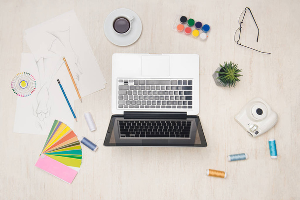 Graphic designer desk essentials top view with wooden texture background. - Photo, Image
