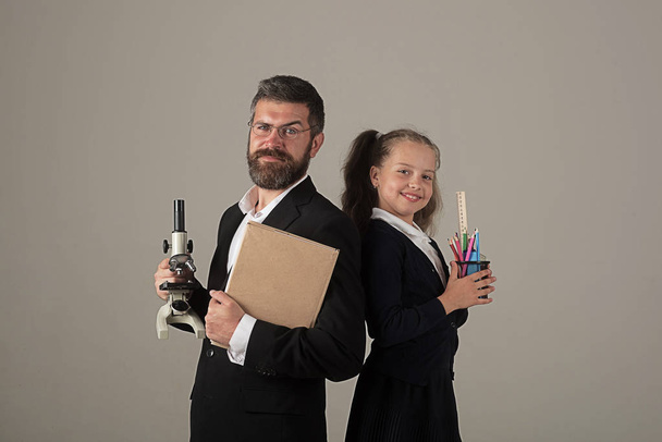 Girl and man in suit and school uniform - Φωτογραφία, εικόνα