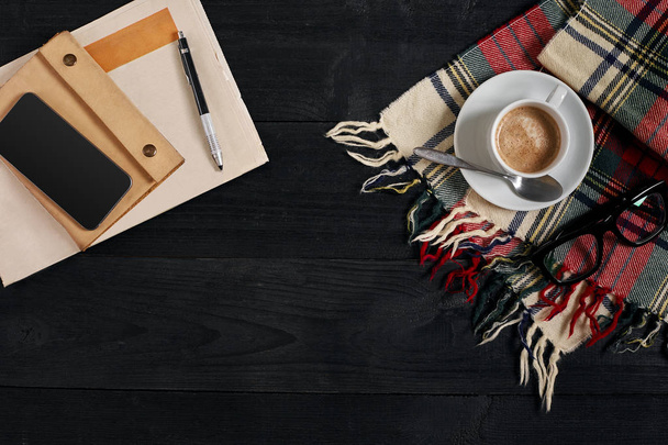 Workspace with newspaper, coffee cup, scarf, glasses. Stylish office desk. Autumn or Winter concept. Flat lay, top view - Photo, Image