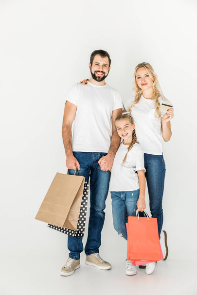 family with shopping bags and credit card - Foto, afbeelding