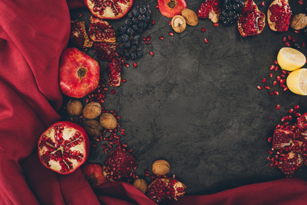 fruits with walnuts and red fabric - Foto, Imagen