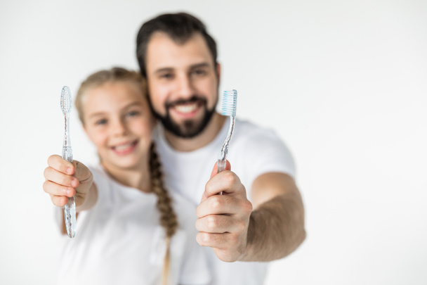father and daughter with toothbrushes - Fotografie, Obrázek