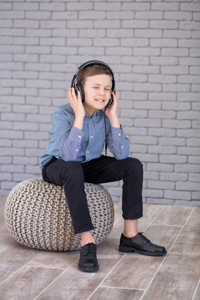 Relax and listening music concept. European boy fill the bit. Boy in casual wear. - 写真・画像