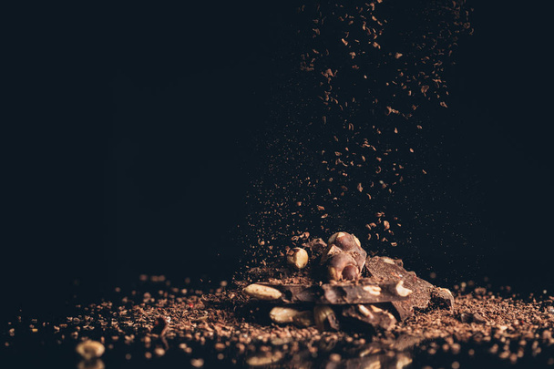 shredded chocolate pieces falling on pile - Foto, afbeelding