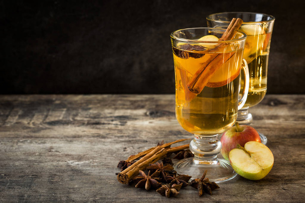 Mulled cider in glass on wooden table. Christmas drink - Photo, Image