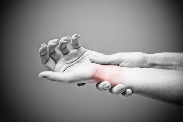 Acute pain in a women wrist - 写真・画像